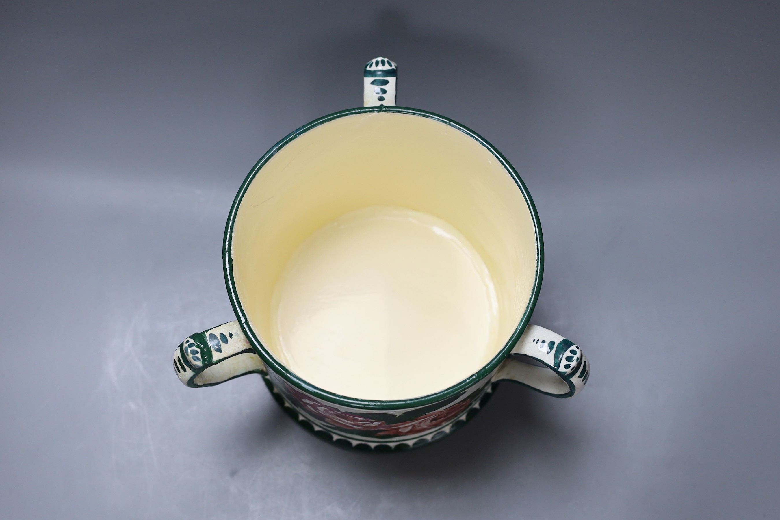 A large Wemyss three handled green and white tankard vase with floral decoration (restored), 19cm tall